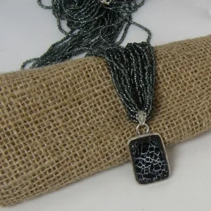 Charcoal Multi-strand Necklace with Dinosaur Bone Pendant