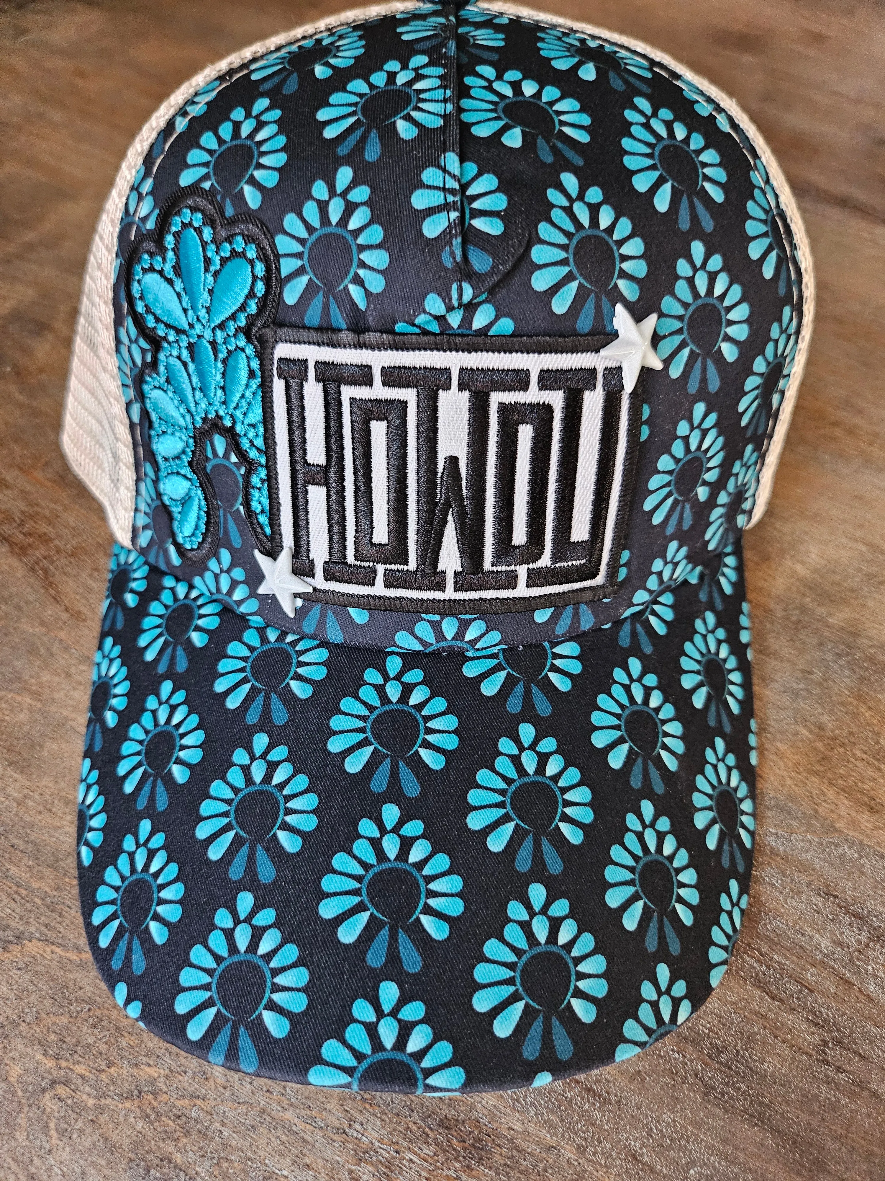 Trucker ponytail hat is custom with embroidered turquoise squash blossom and "Howdy" patches and star studs