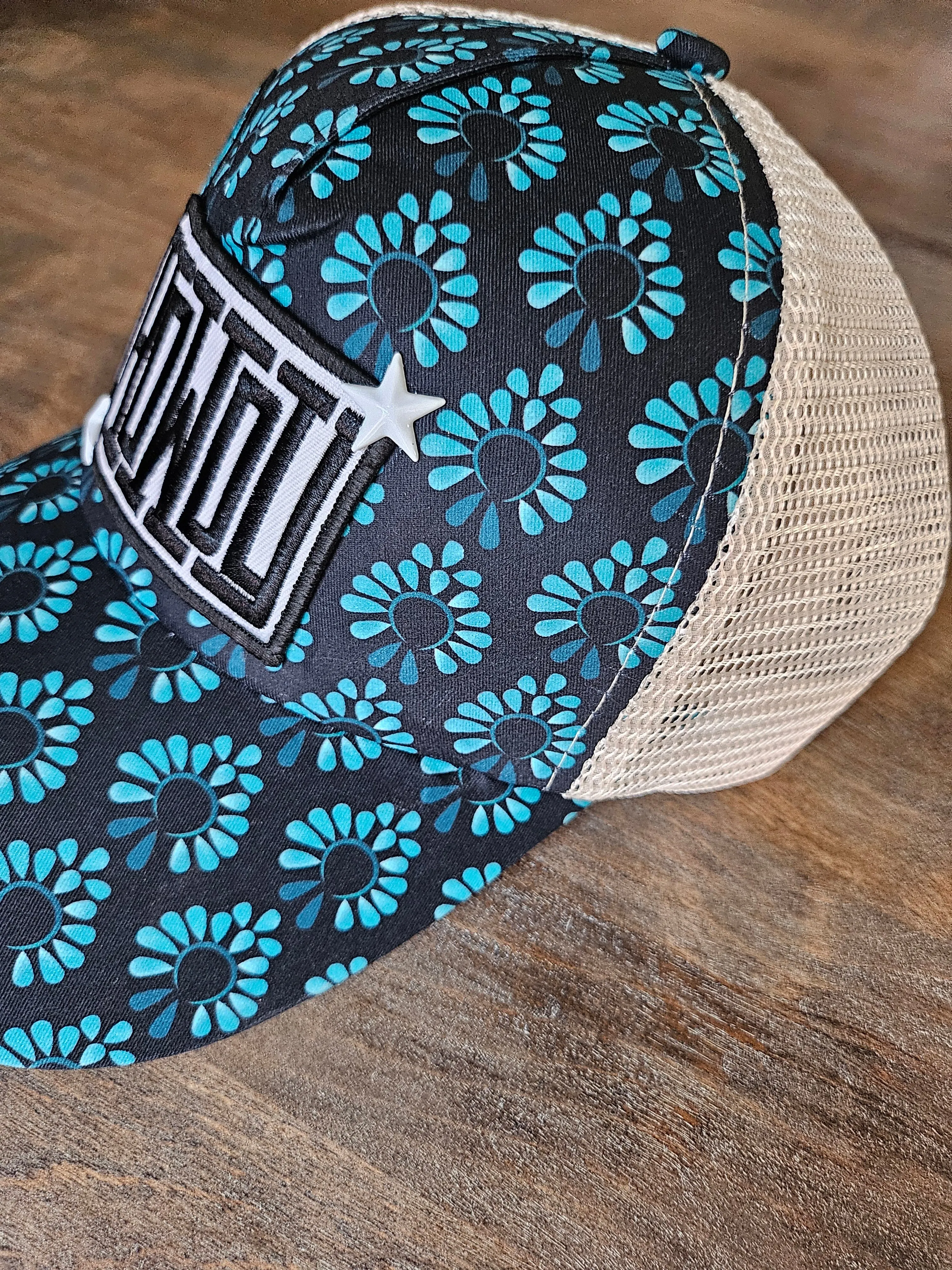 Trucker ponytail hat is custom with embroidered turquoise squash blossom and "Howdy" patches and star studs